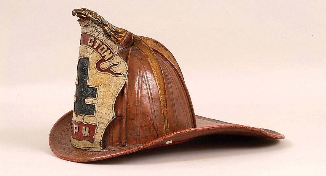 Historic leather firefighter helmet with visible wear and scuffs, representing the long-standing firefighter helmet tradition.