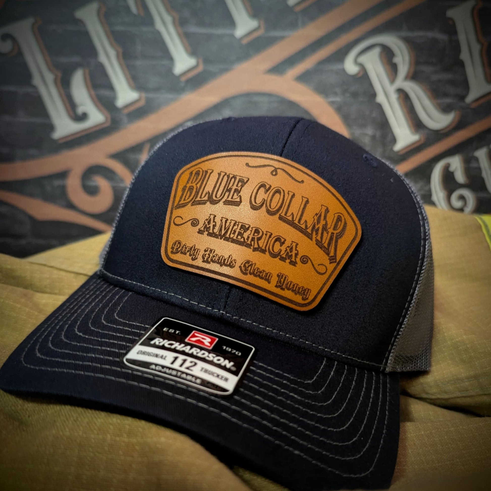 Hat with leather patch reading βBlue Collar America β Dirty Hands, Clean Moneyβ on Richardson 112 hat