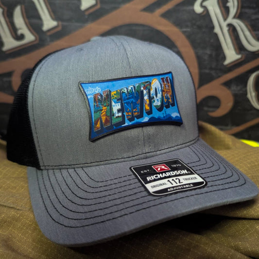 Richardson hat with leather patch featuring Newton NC mural artwork from downtown.
