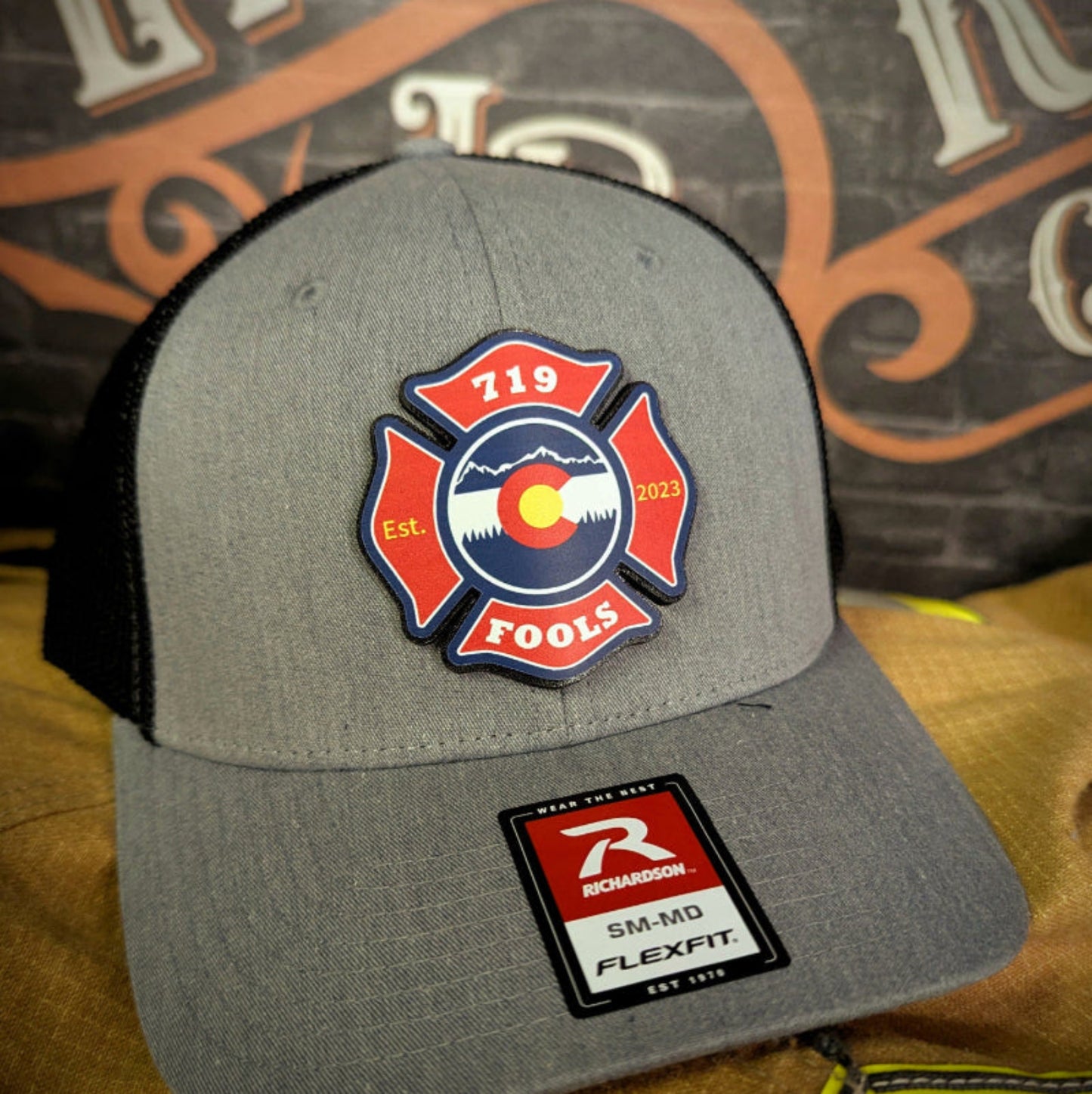 Richardson firefighter hat with 719 FOOLS leather patch β skull logo, axes, and Colorado pride