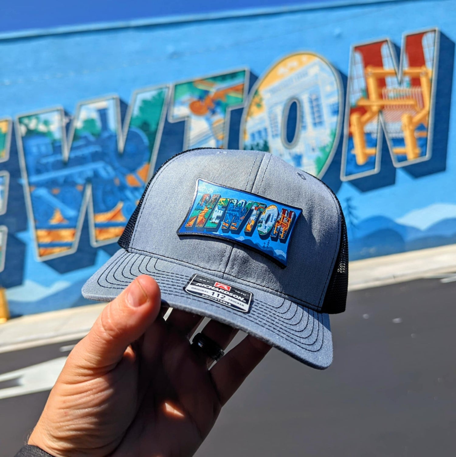 Richardson hat with leather patch featuring Newton NC mural artwork from downtown.