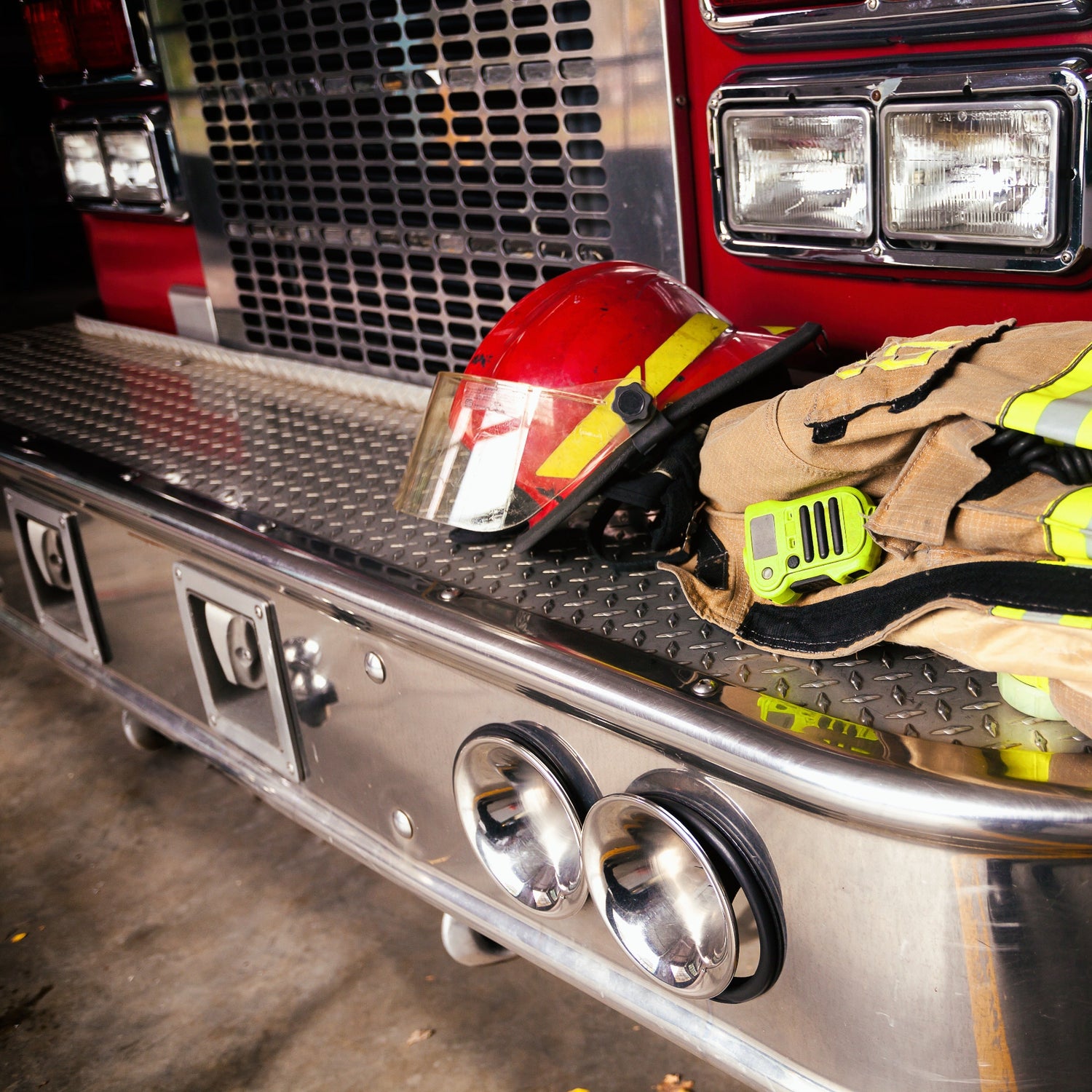 Front bumper of a firetruck with firefighter gear staged—representing the real-world roots of The Front Bumper blog, where custom firefighter gear and LRC product insights come together.
