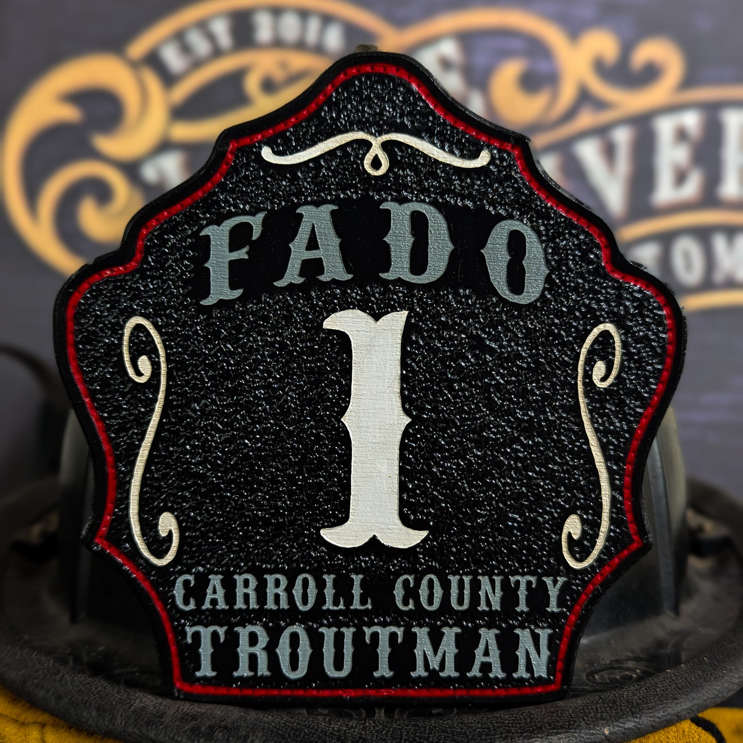 Black leather firefighter helmet shield with Carroll County FADO design and bold white number 1.