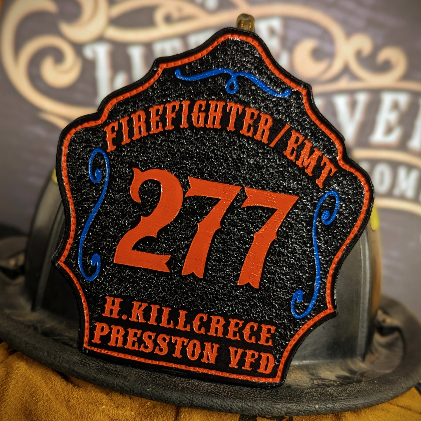 Leather firefighter helmet shield with Presston VFD design, large red number 277, and firefighter EMT details.