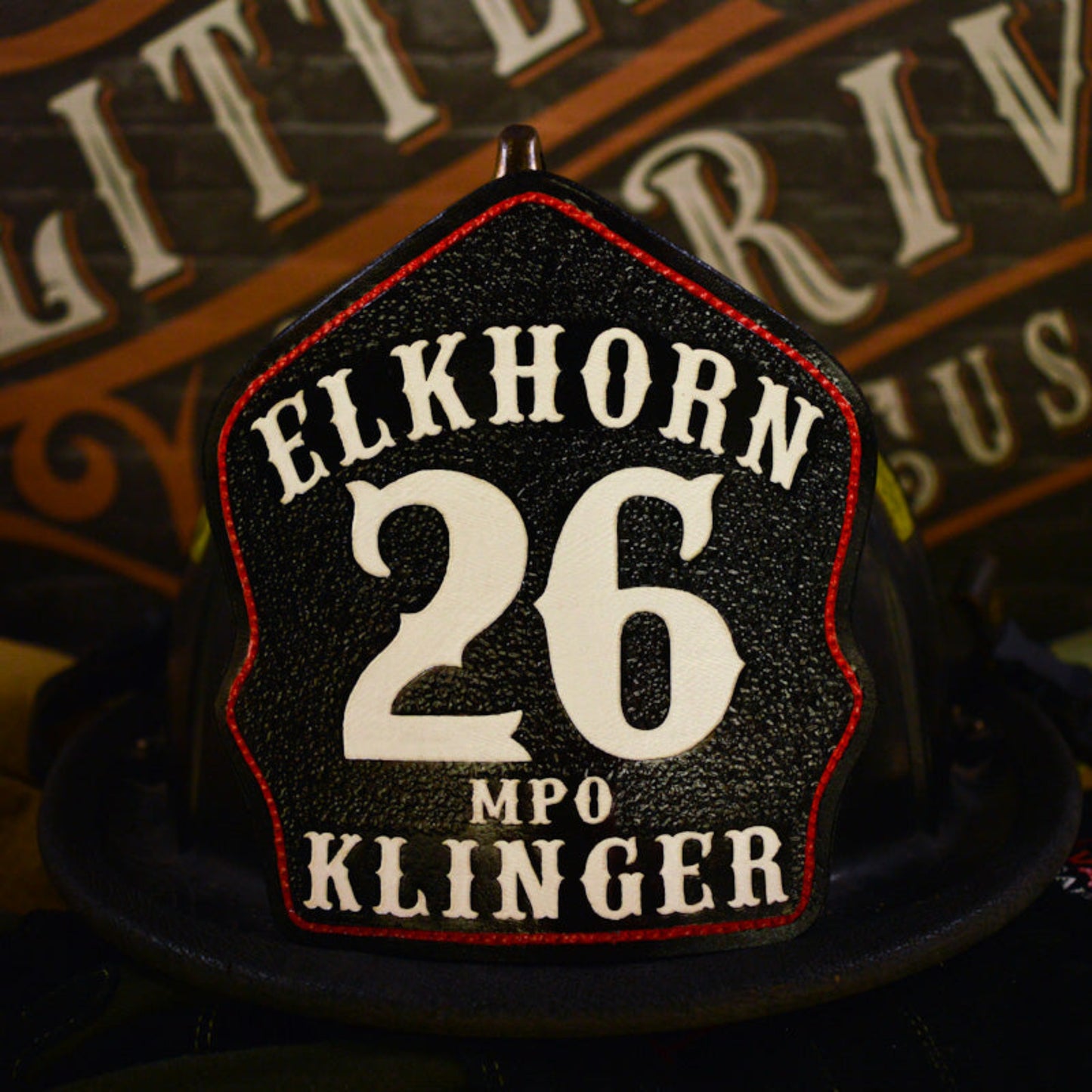 Custom leather firefighter helmet shield, Elkhorn Fire, black with white 26 and MPO Klinger, red border outline, hand painted by Little River Customs