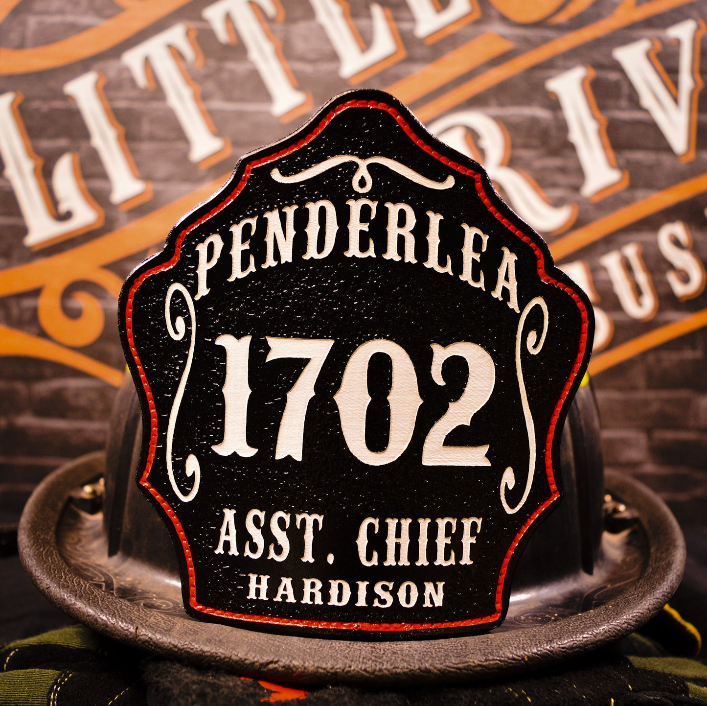 Custom leather firefighter helmet shield for Penderlea, black with white 1702 and Asst. Chief Hardison, red outline by Little River Customs