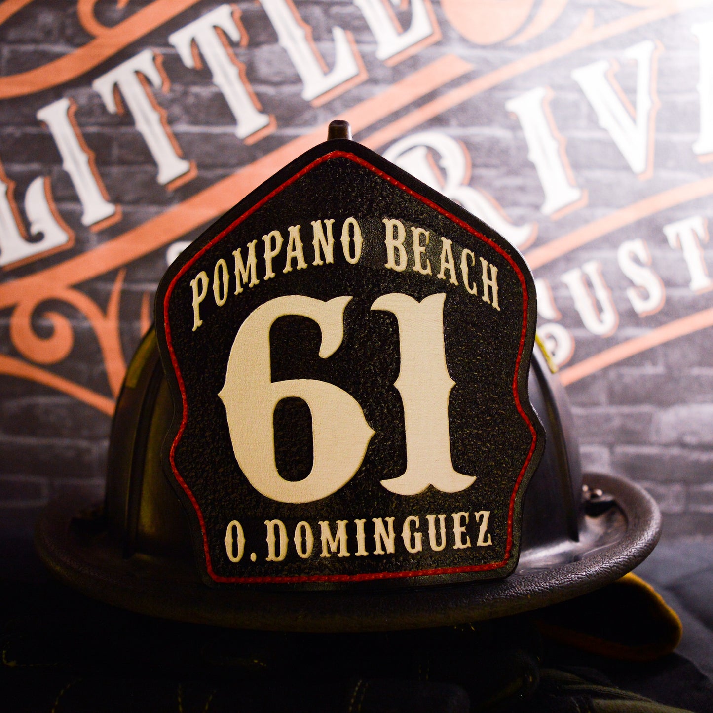 Custom leather firefighter helmet shield for Pompano Beach, black with white 61 and O. Dominguez, red outline by Little River Customs