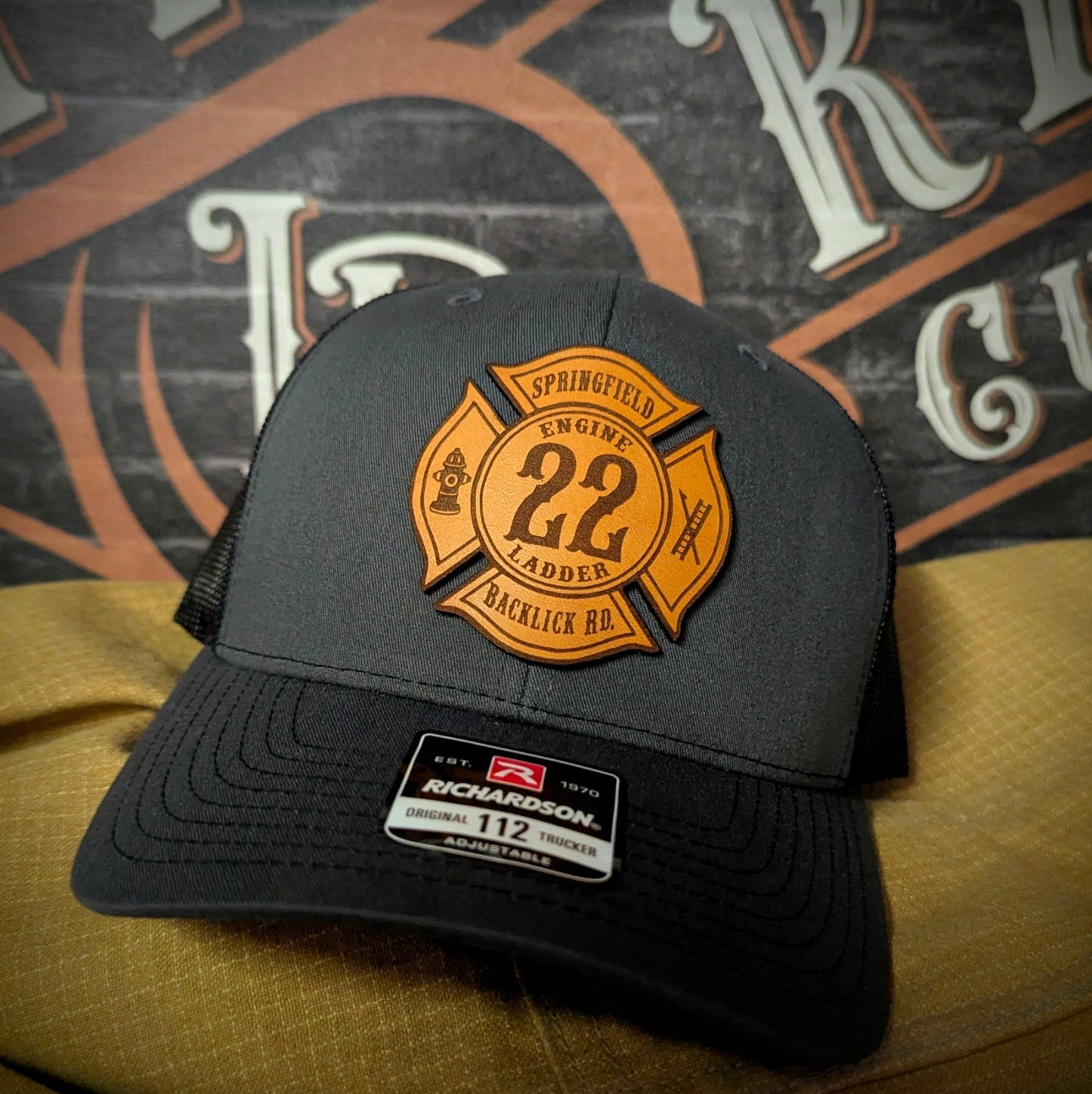 Gray Richardson firefighter hat with custom Maltese leather patch design, built tough for fire department crews.