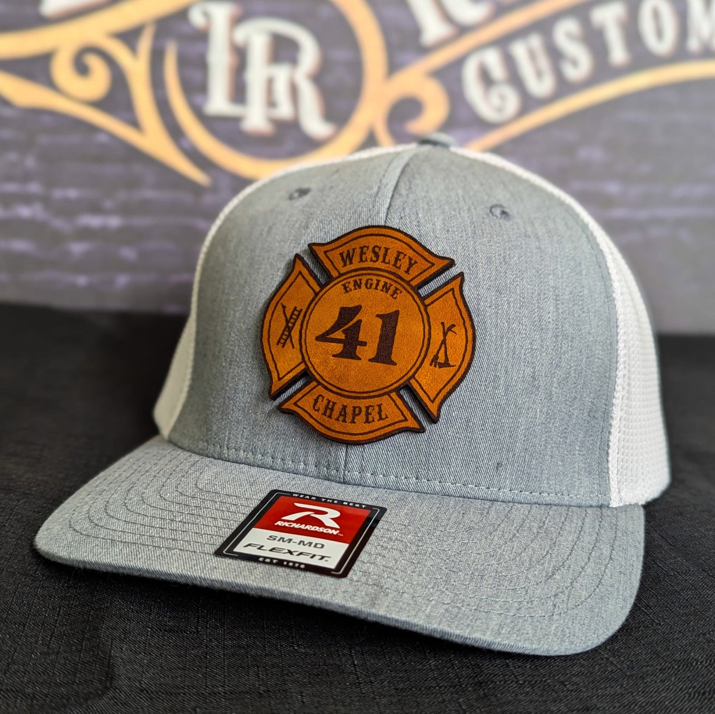Light gray Richardson firefighter hat with custom Maltese leather patch design, Flexfit style built for fire department crews.