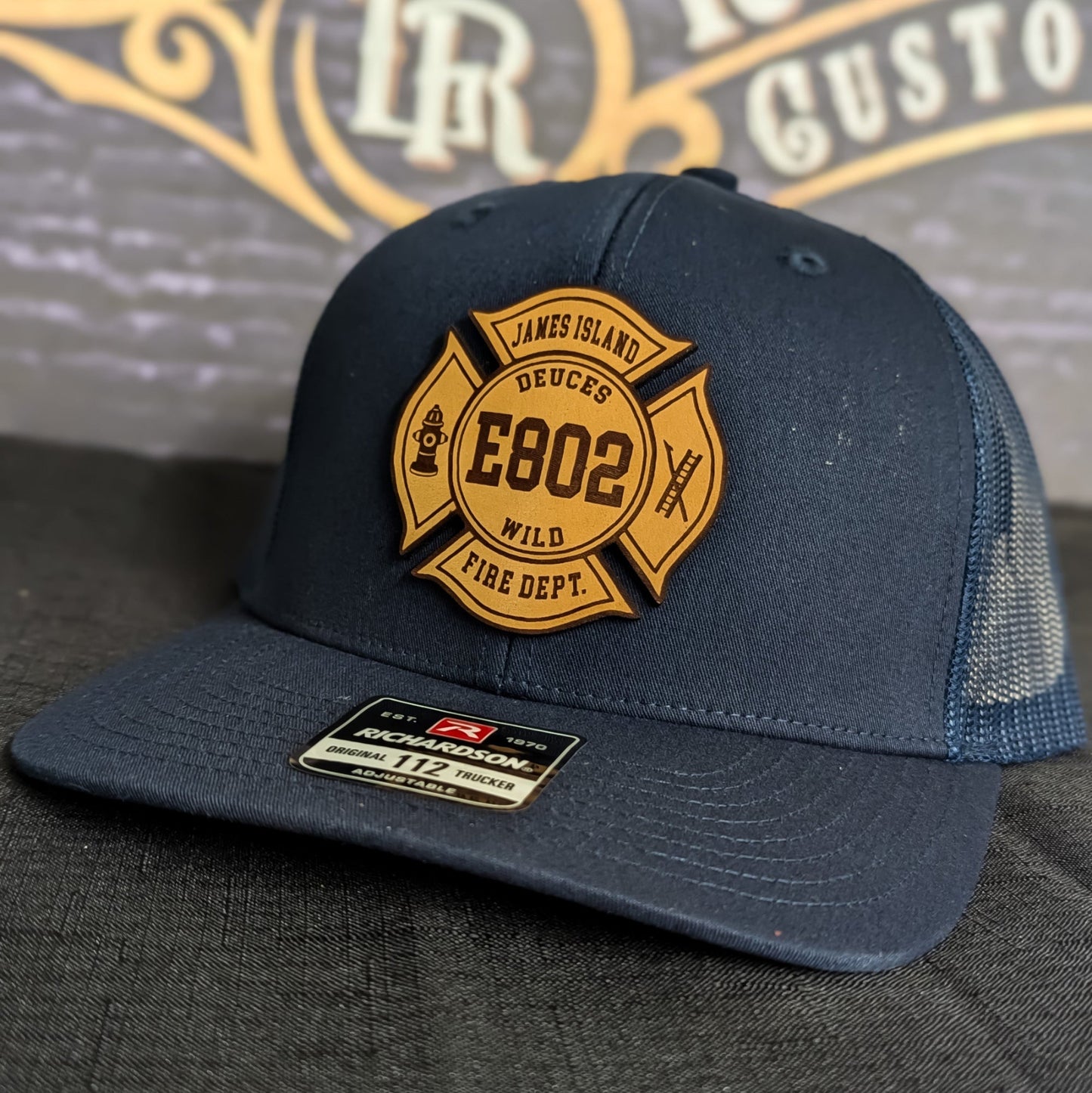 Navy Richardson firefighter hat with custom Maltese leather patch design, tough and professional headwear for fire department crews.