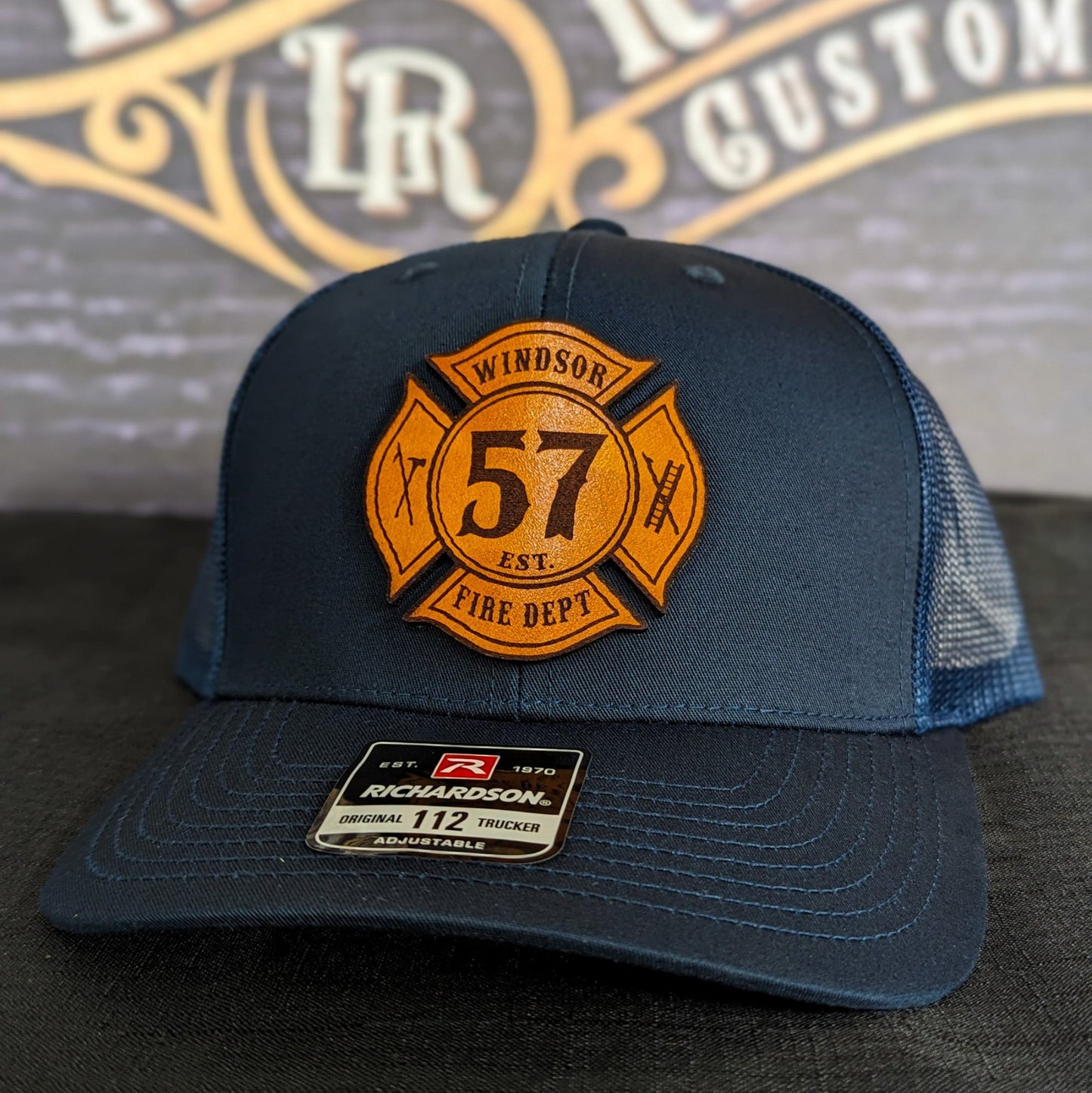 Navy Richardson firefighter hat with custom Maltese leather patch design, durable mesh back style for fire department crews.
