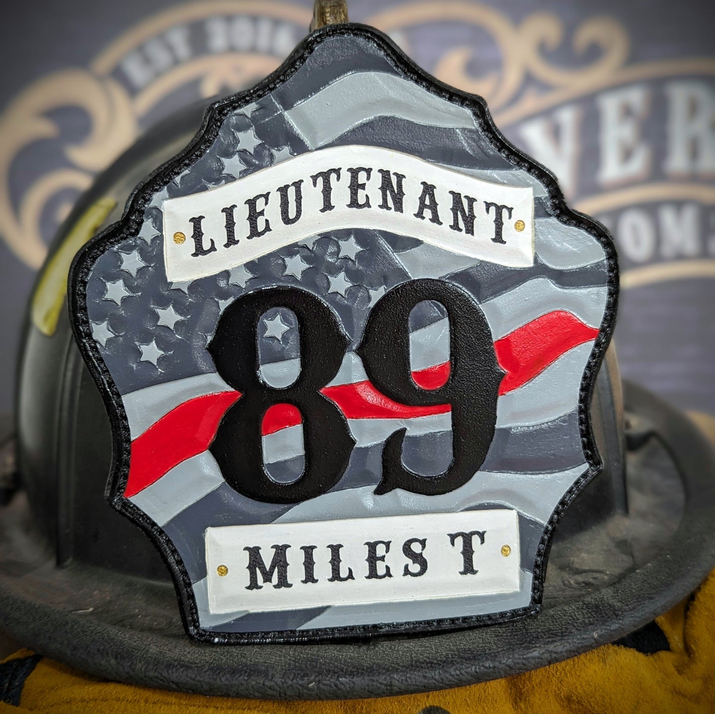 Custom firefighter helmet shield with American flag design, personalized leather front with unit number and firefighter name. Handcrafted fire helmet shield for professional firefighters, made for durability and pride on the job.