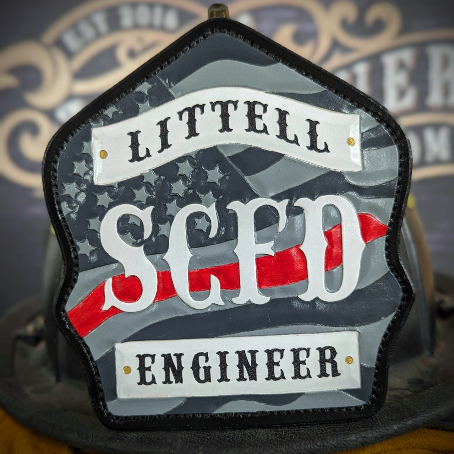 Custom firefighter helmet shield with American flag design, personalized leather front with unit number and firefighter name. Handcrafted fire helmet shield for professional firefighters, made for durability and pride on the job.