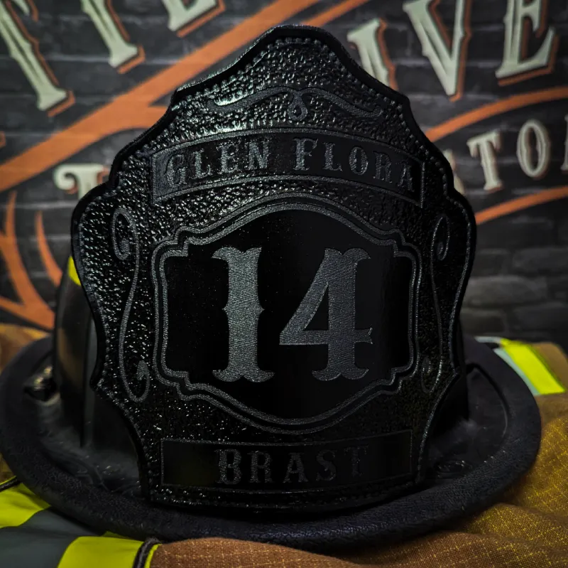 Standard Issue custom leather firefighter helmet shield in black-on-black design with raised numbers and subtle embossed lettering.