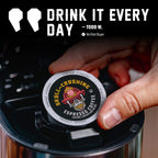 Hand placing a Skull-Crushing Espresso Pods single pod into a coffee maker beside a customer quote
