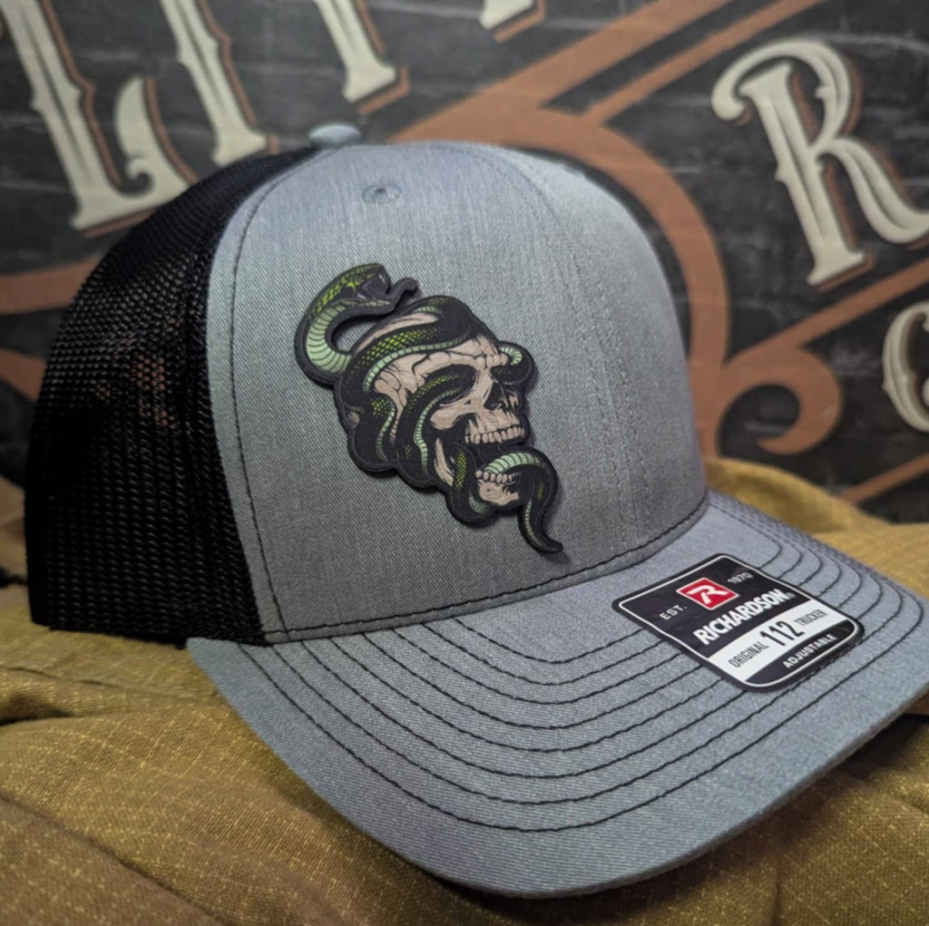 Custom Richardson hat with leather patch featuring skull and green snake design – dark streetwear style.