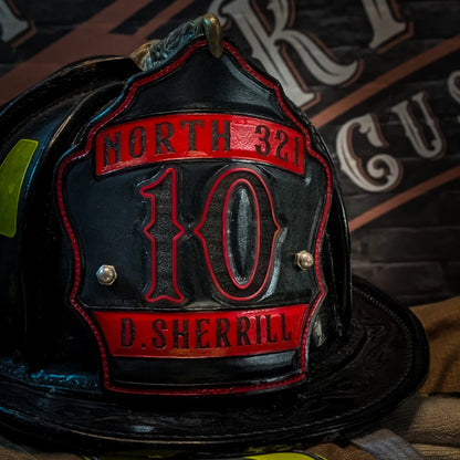 Custom fire helmet front for north 321 firefighter. Black leather with red banners