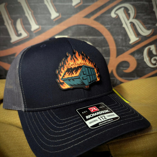 Richardson 112 snapback hat featuring a full-color leather patch of a flaming dumpster, known as the iconic dumpster fire design.