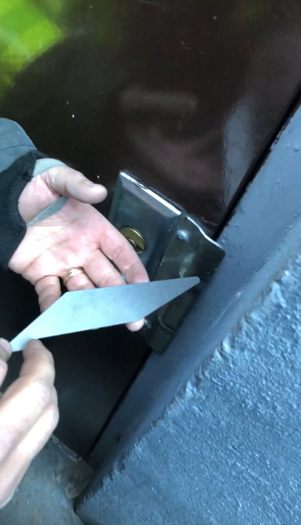 FirePik positioned behind outward opening door latch plate