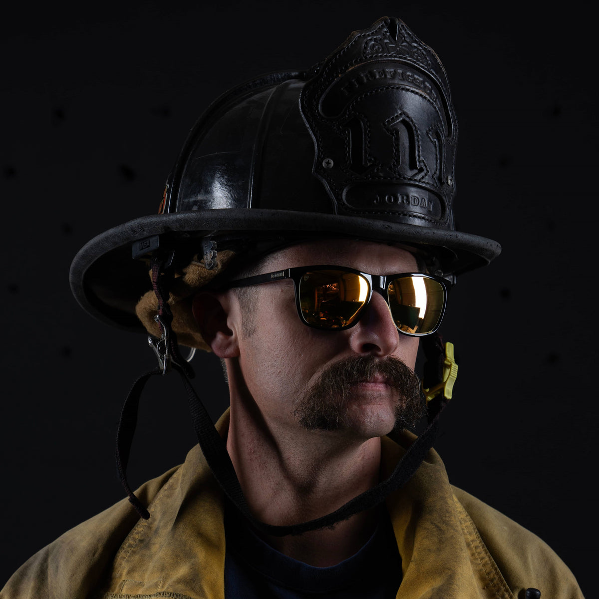 Nado Sunset firefighter wearing gold mirrored sunglasses with a helmet