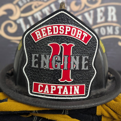 Custom leather firefighter helmet shield on a textured black field with classic engine layout—hand-painted, helmet mounted.