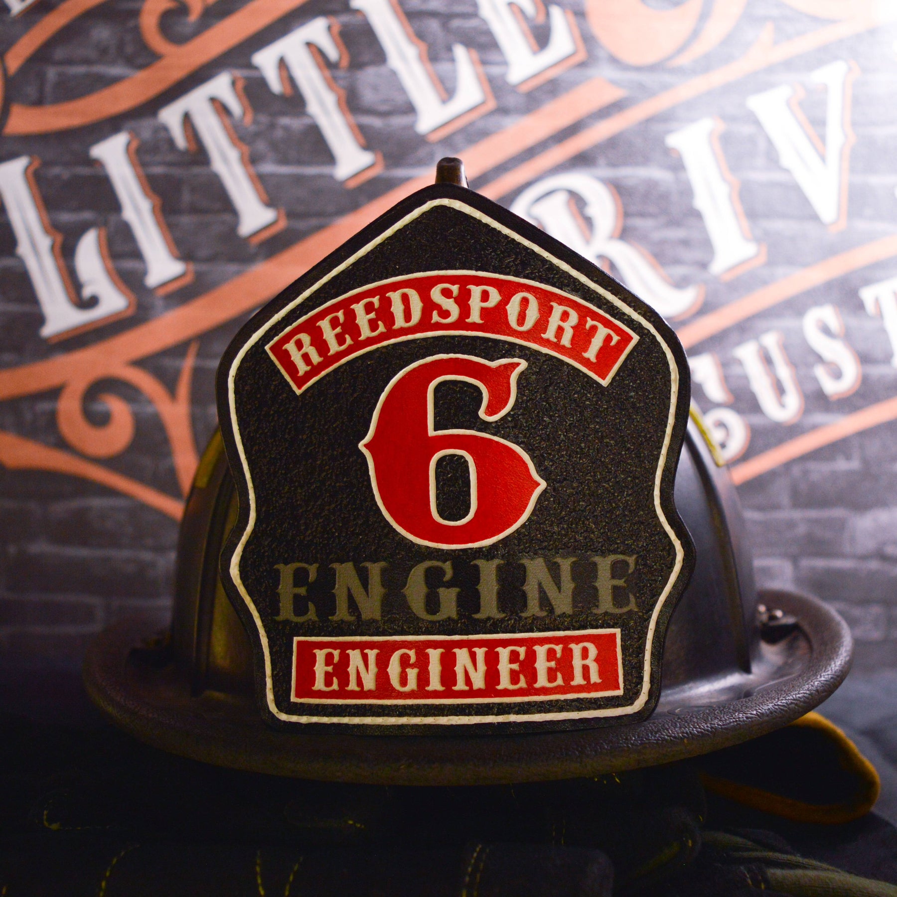Red framed leather firefighter helmet shield with gold trim, hand-painted and helmet mounted.