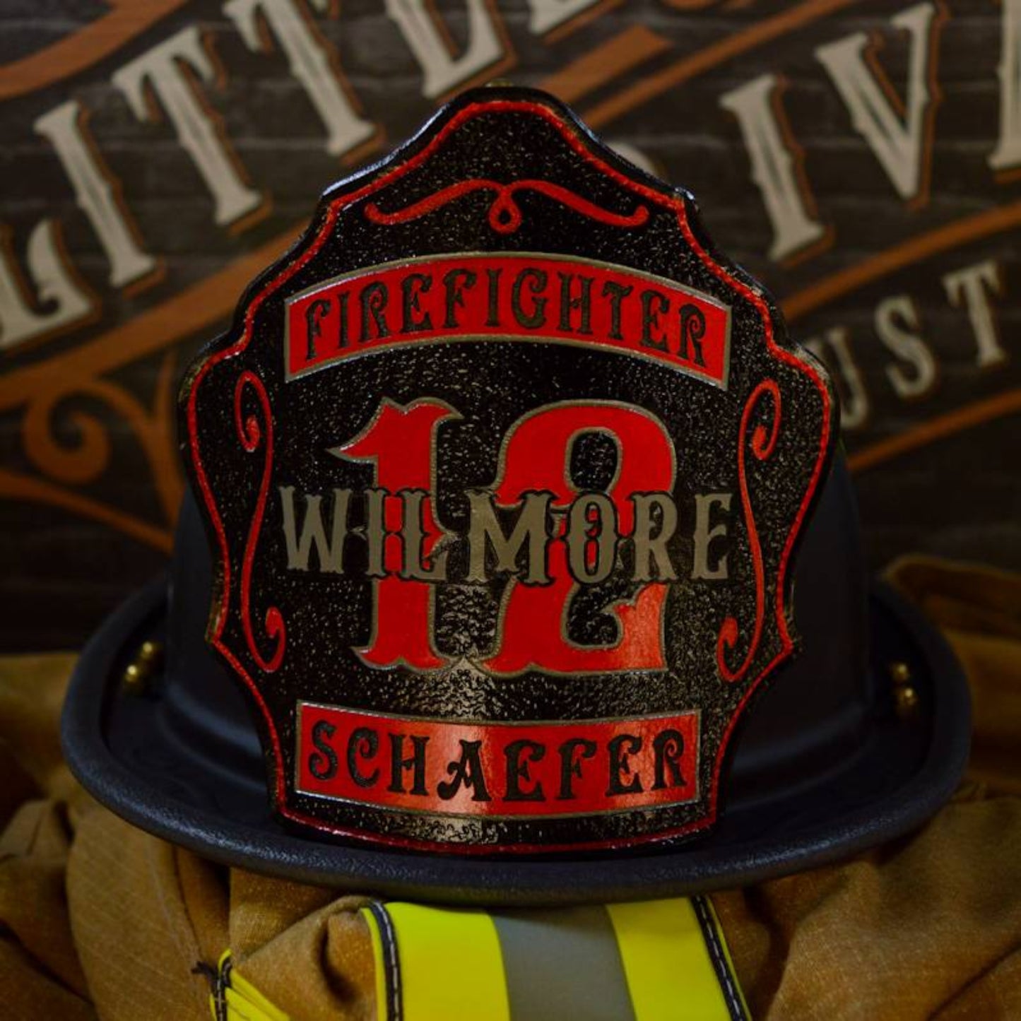 Truck layout leather firefighter helmet shield with bold white lettering and a gray center panel.