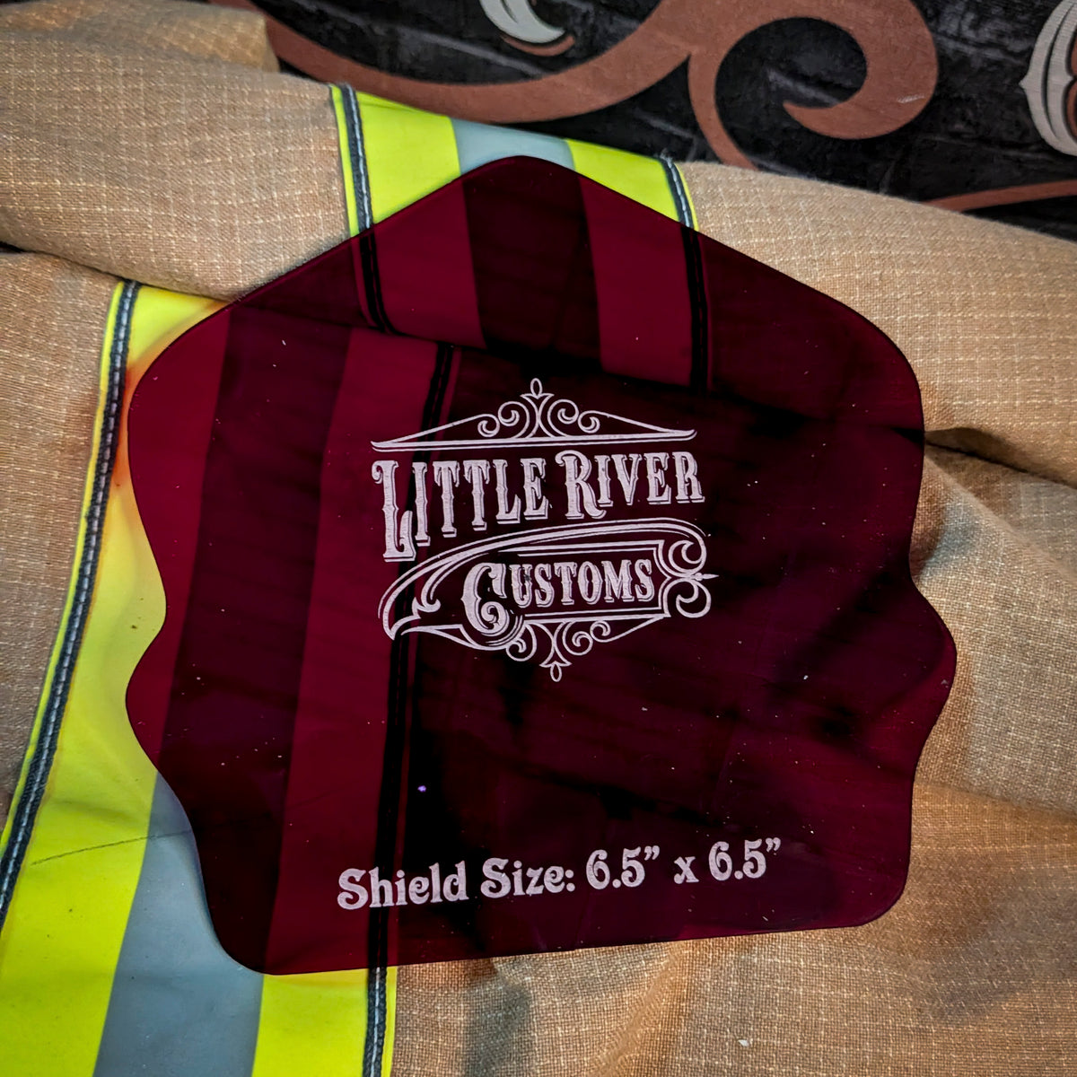 Red acrylic firefighter helmet shield template with rounded shoulders on turnout gear