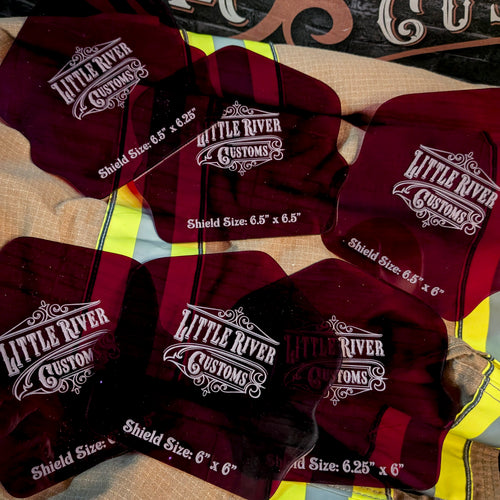 Six rounded acrylic firefighter helmet shield templates showing different size markings