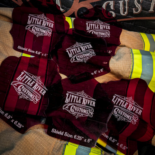Scalloped acrylic firefighter helmet shield templates in assorted sizes on turnout gear