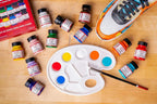 Angelus Best Sellers paints arranged with a mixing palette, brush, and sneaker