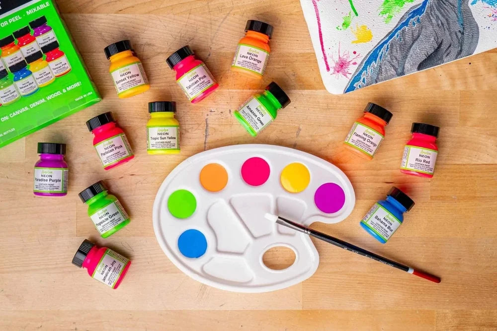 Angelus neon paints arranged around a colorful palette and painted sneaker