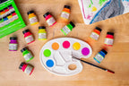 Angelus neon paints arranged around a colorful palette and painted sneaker