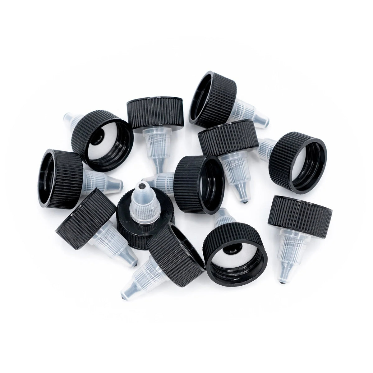 Loose Angelus twist top caps showing black threads and clear dispensing tips