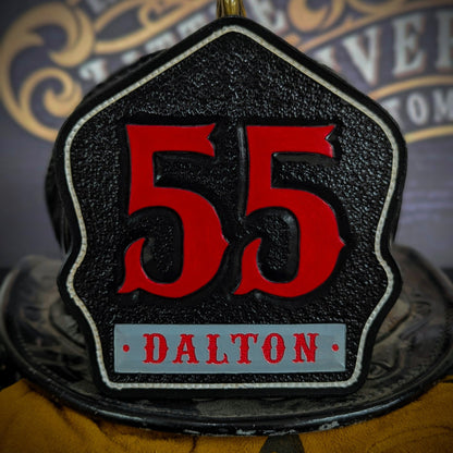Black leather firefighter helmet shield with large red numerals “55” and a gray nameplate reading DALTON—mounted on a helmet.
