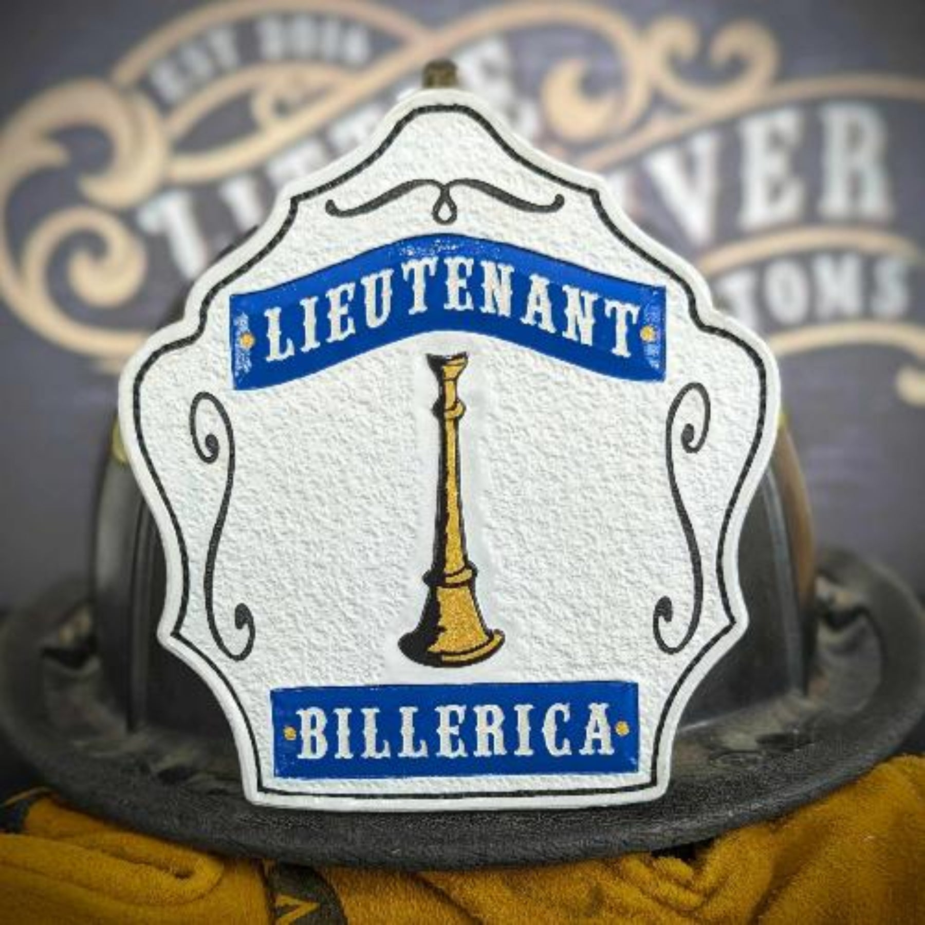 Blue center-panel lieutenant helmet shield with single gold bugle and white frame.