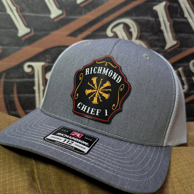 Custom firefighter hat with leather patch design in black and gold on Richardson hat.