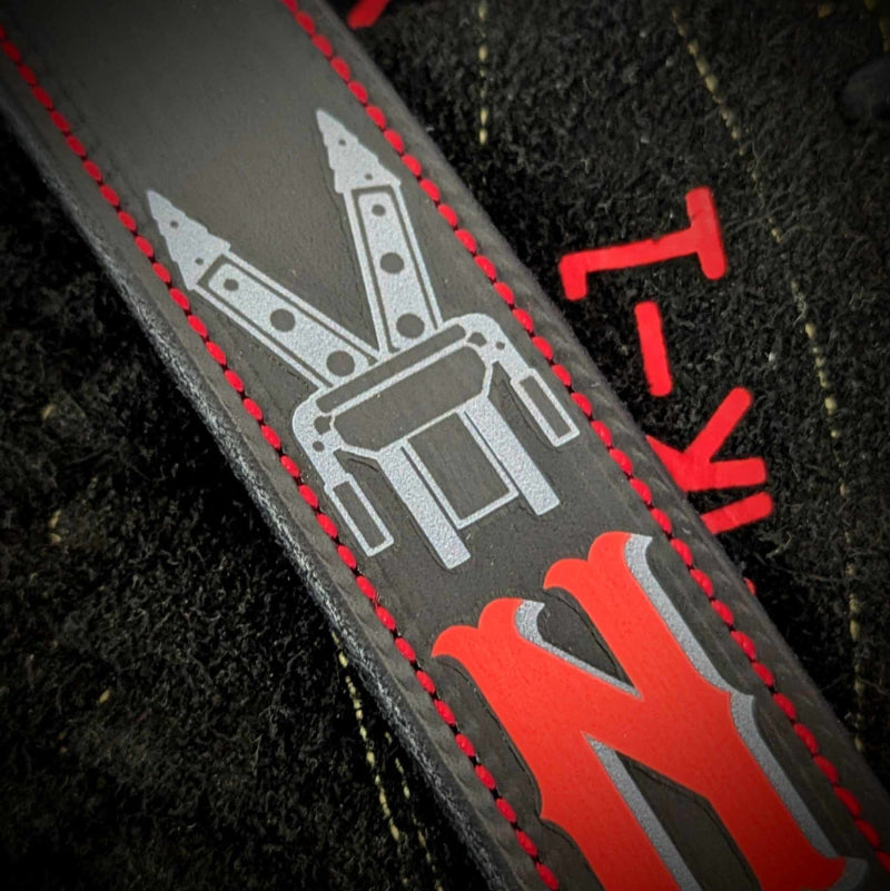 Black leather firefighter radio strap with red lettering