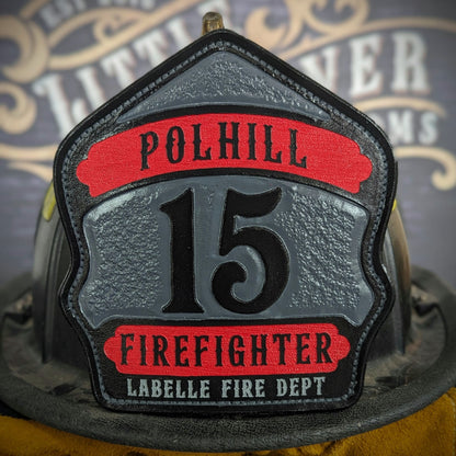 ustom leather firefighter helmet shield with gray center panel, red top and bottom banners, and bold black numeral—hand-painted and mounted on a helmet.