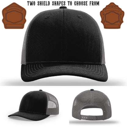 Station hat with two different leather shield patch shapes