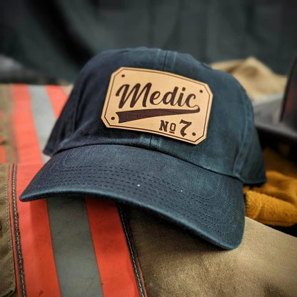 EMT apparel hat featuring passport style leather patch personalization