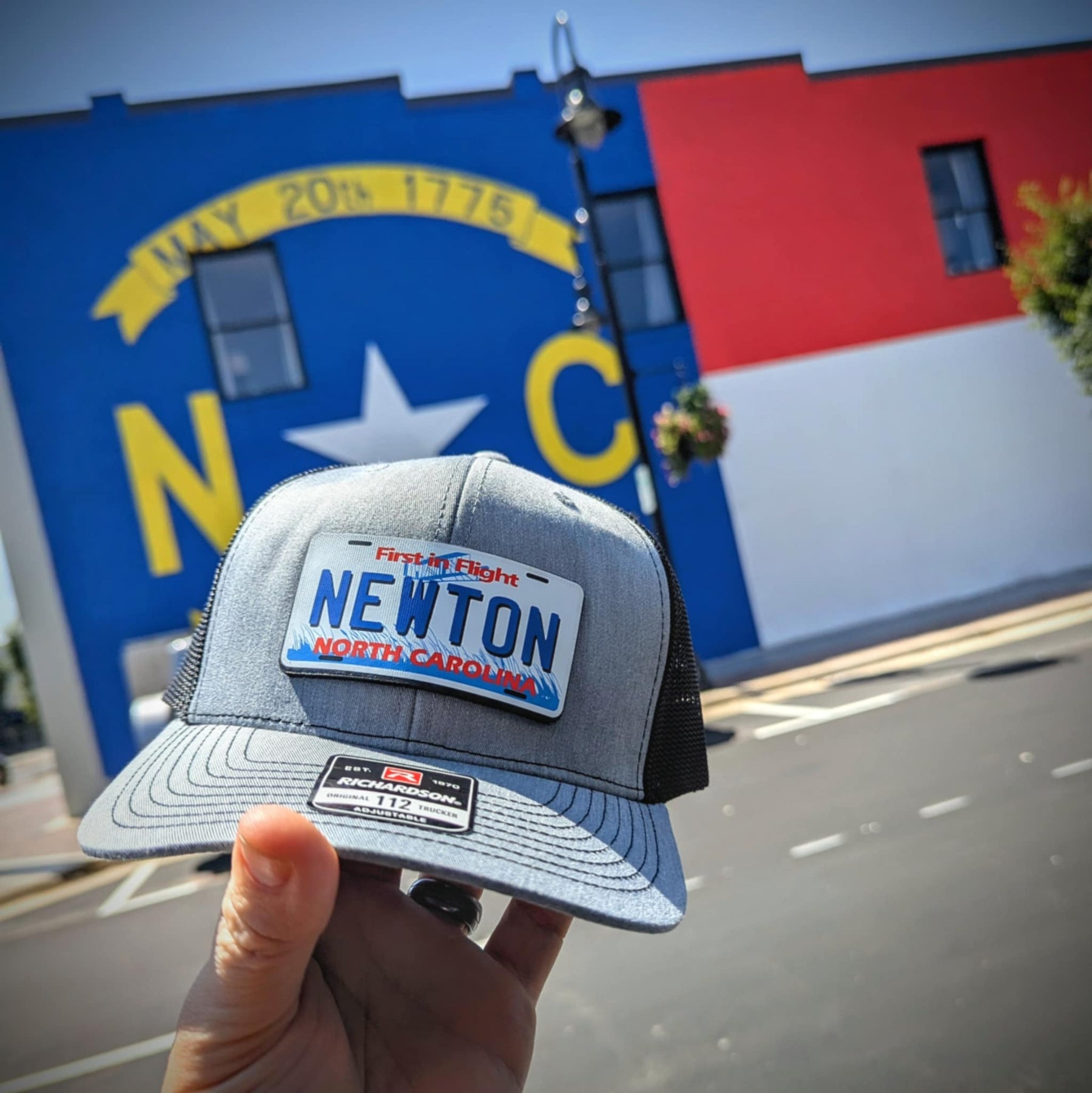 Custom leather patch hat styled like a state license plate with bold detail
