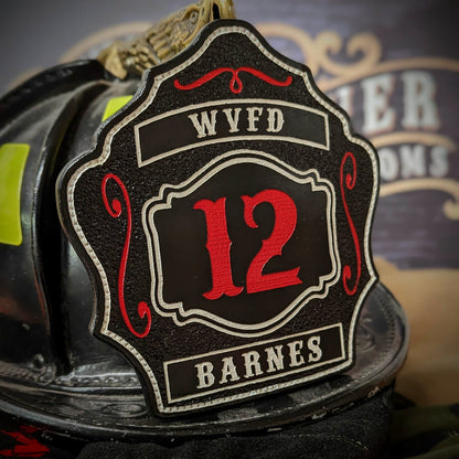 Custom black leather firefighter helmet shield with number 12 in red, white borders, and red scroll accents