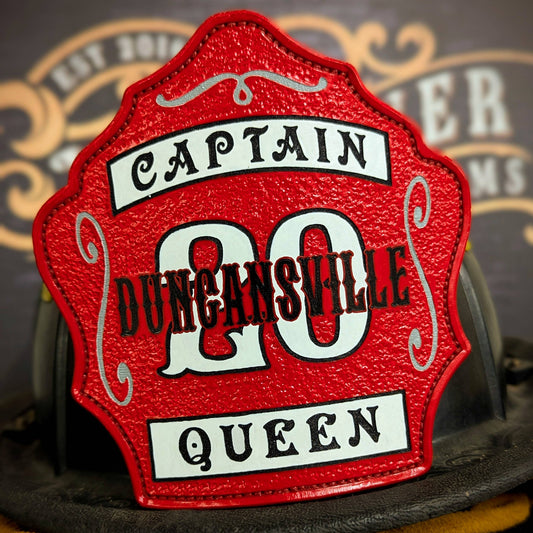 Red leather firefighter helmet shield with bold white number 20 and black lettering, custom fire department gear.