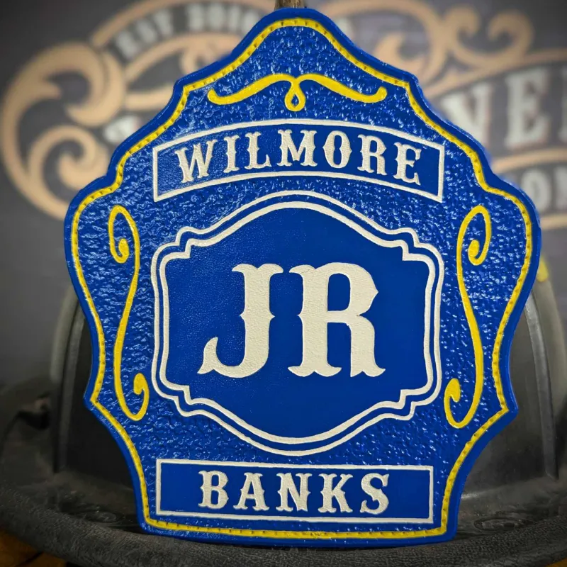 Standard Issue custom firefighter helmet shield in bold blue leather with Wilmore lettering, JR center initials, and Banks name accent in white and yellow trim.