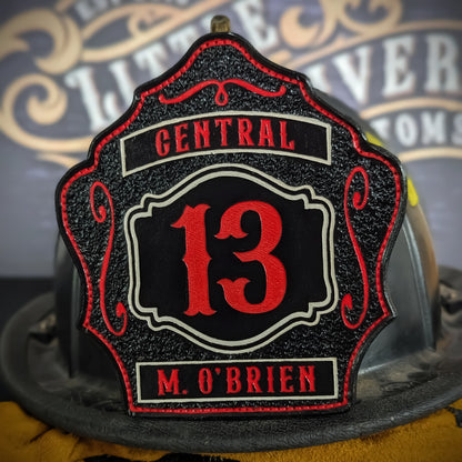 Black leather firefighter helmet shield with red number 13, Central text above, and name M. O’Brien at the bottom.