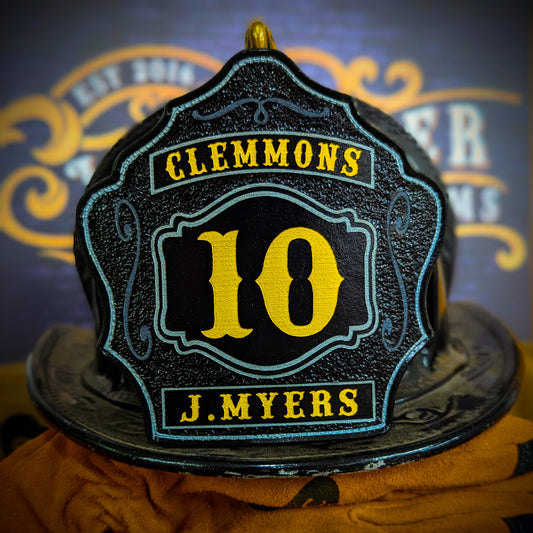 Black leather firefighter helmet shield with yellow number 10, Clemmons lettering, and J. Myers name in bold.