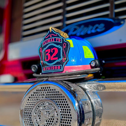 Blue firefighter helmet with black leather shield featuring red number 32, Climax FD text, and name B. Faison at the bottom.