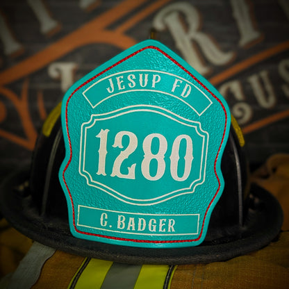 Teal leather firefighter helmet shield with white Jesup FD text, large 1280 number, and name G. Badger at the bottom.