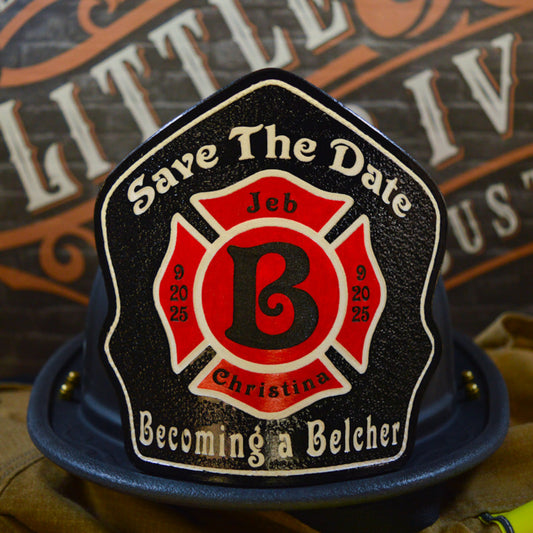 Custom firefighter helmet shield with a black background, red Maltese cross, bold letter B, and personalized wedding details for Jeb and Christina with "Save The Date" and "Becoming a Belcher" text.